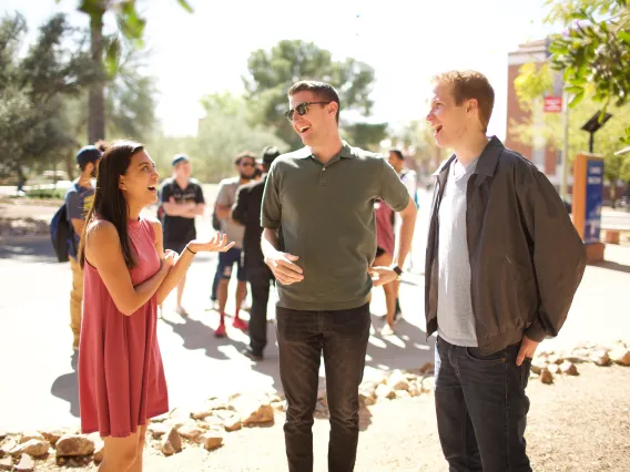 A group of students talking and laughing.