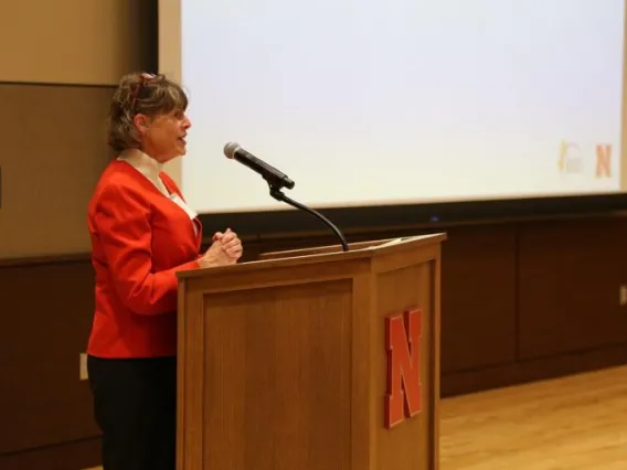 Picture of Kitt Farrell-Poe in front of podium