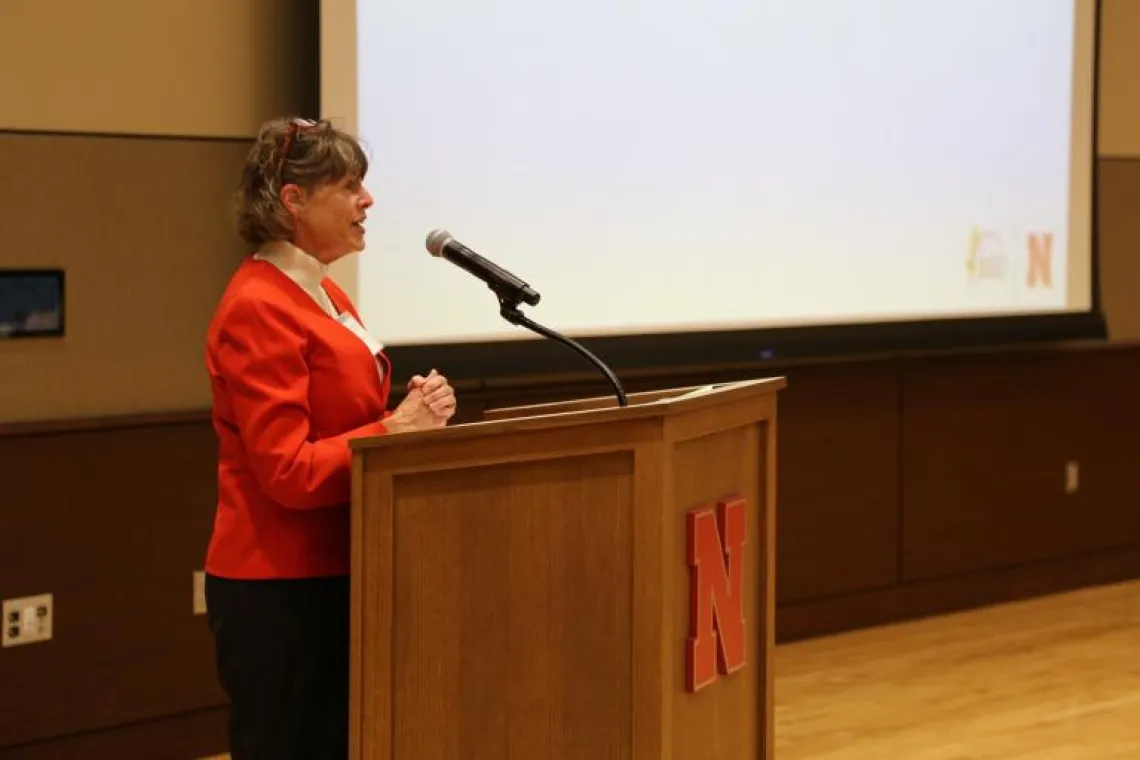 Picture of Kitt Farrell-Poe in front of podium