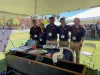 Photo of team members in front of table with engineering project.